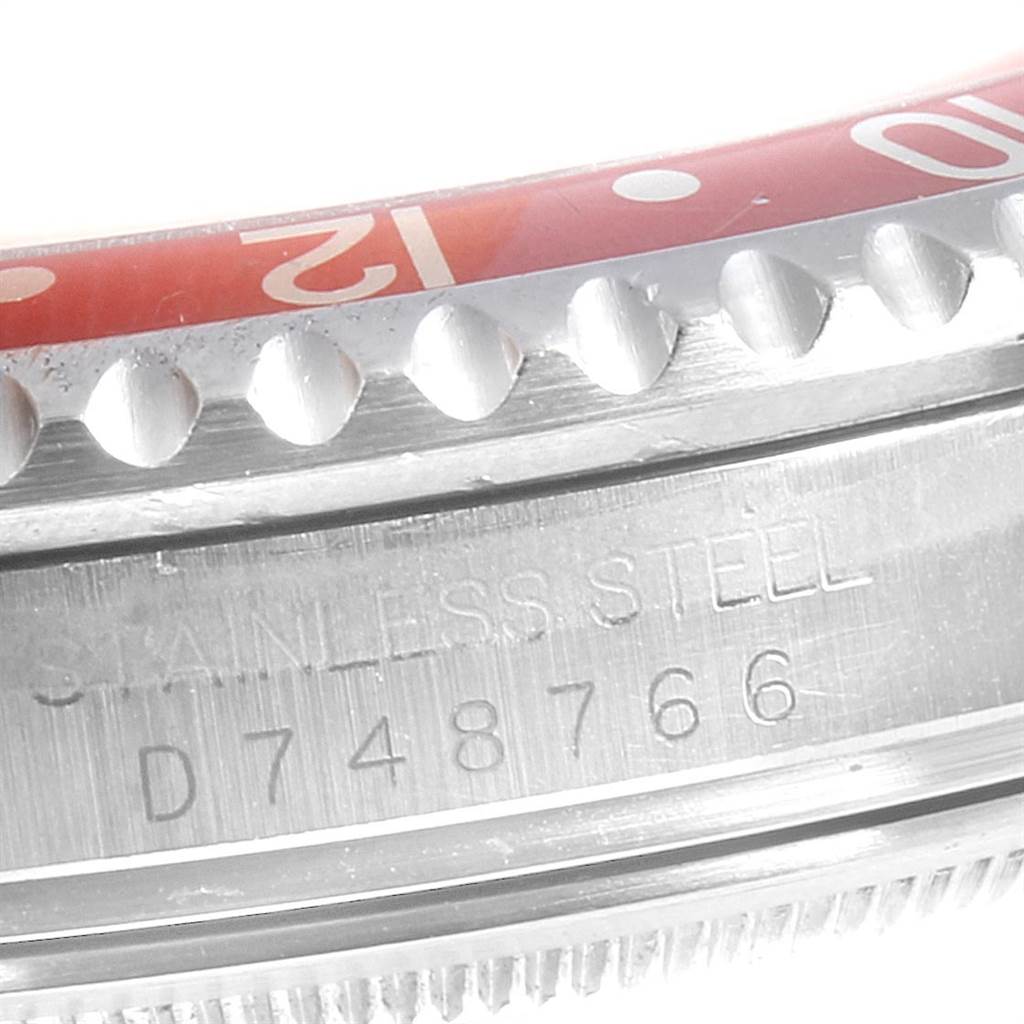 The image shows a close-up of the bezel and case engraving of a Rolex GMT-Master 16710 Men's Stainless Steel Black Dial 16710 Men's Stainless Steel Black Dial watch.