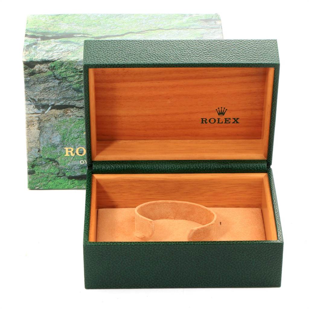 The image shows an open Rolex GMT-Master 16713 Men's Stainless Steel Black Dial 16713 Men's Stainless Steel Black Dial box with a green exterior and wooden interior.