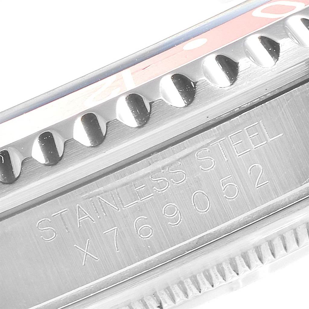 Close-up of a Rolex GMT-Master 16700 Men's Stainless Steel Black Dial 16700 Men's Stainless Steel Black Dial watch showing the stainless steel case with engraved serial number and part of the bezel teeth.