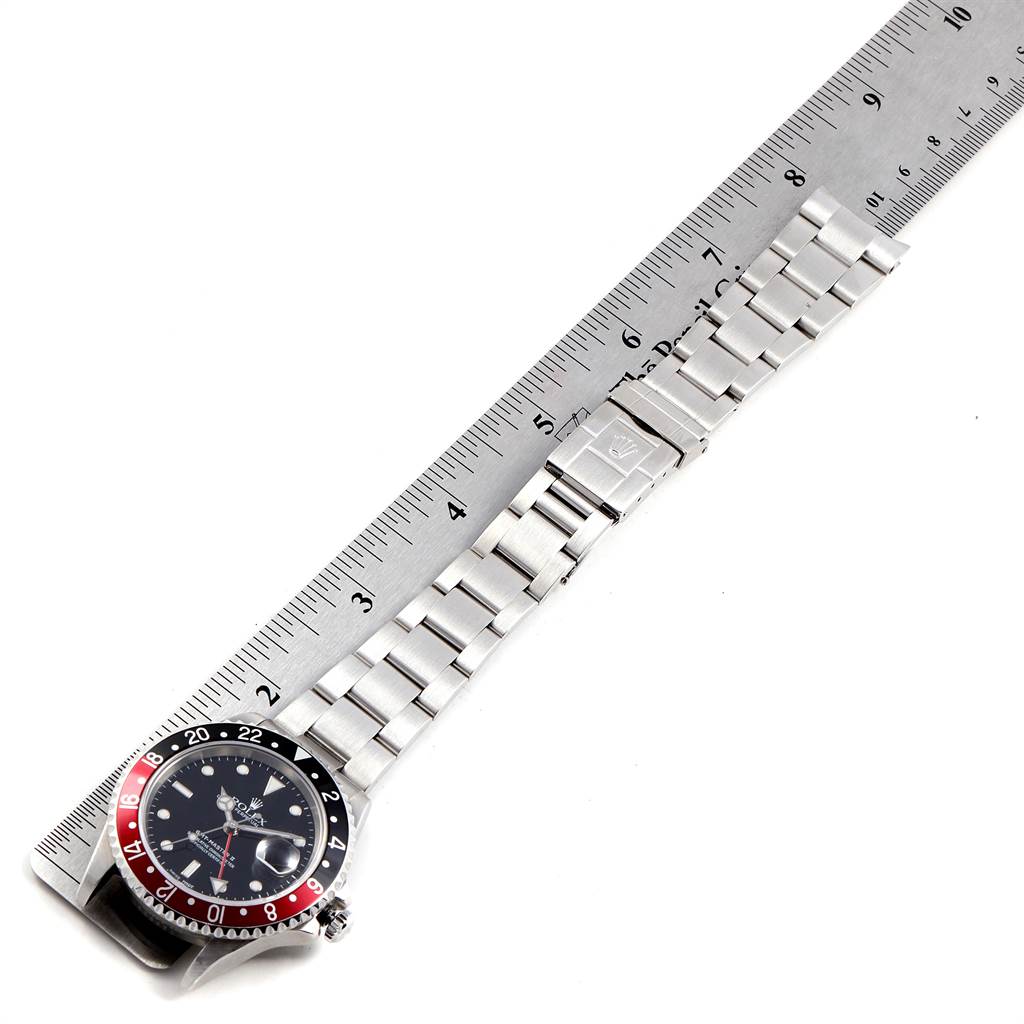 The image shows a top view of a Rolex GMT-Master 16710 Men's Stainless Steel Black Dial 16710 Men's Stainless Steel Black Dial watch with its full bracelet, measured against a ruler.