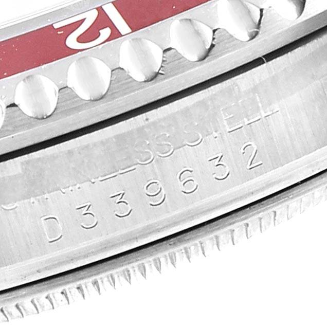 This close-up image shows the bezel and serial number engraving of a Rolex GMT-Master 16710 Men's Stainless Steel Black Dial 16710 Men's Stainless Steel Black Dial watch.