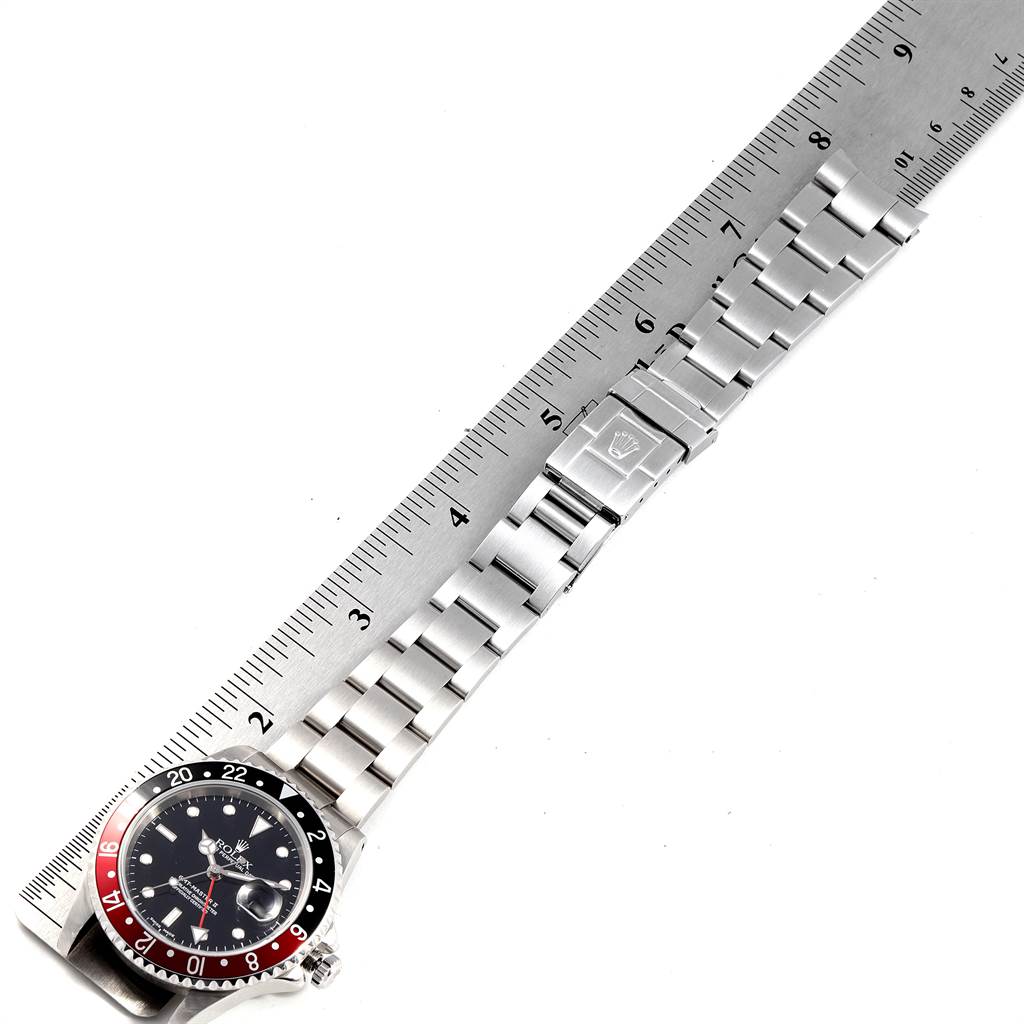 This image shows the Rolex GMT-Master 16710 Men's Stainless Steel Black Dial 16710 Men's Stainless Steel Black Dial watch laid flat, displaying the face, bezel, and full bracelet with a ruler for scale.