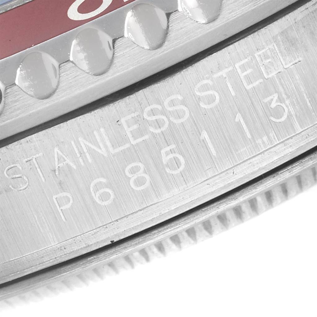 The image shows a close-up of the side of a Rolex GMT-Master 16710 Men's Stainless Steel Black Dial 16710 Men's Stainless Steel Black Dial watch, highlighting the stainless steel casing and engraved serial number.