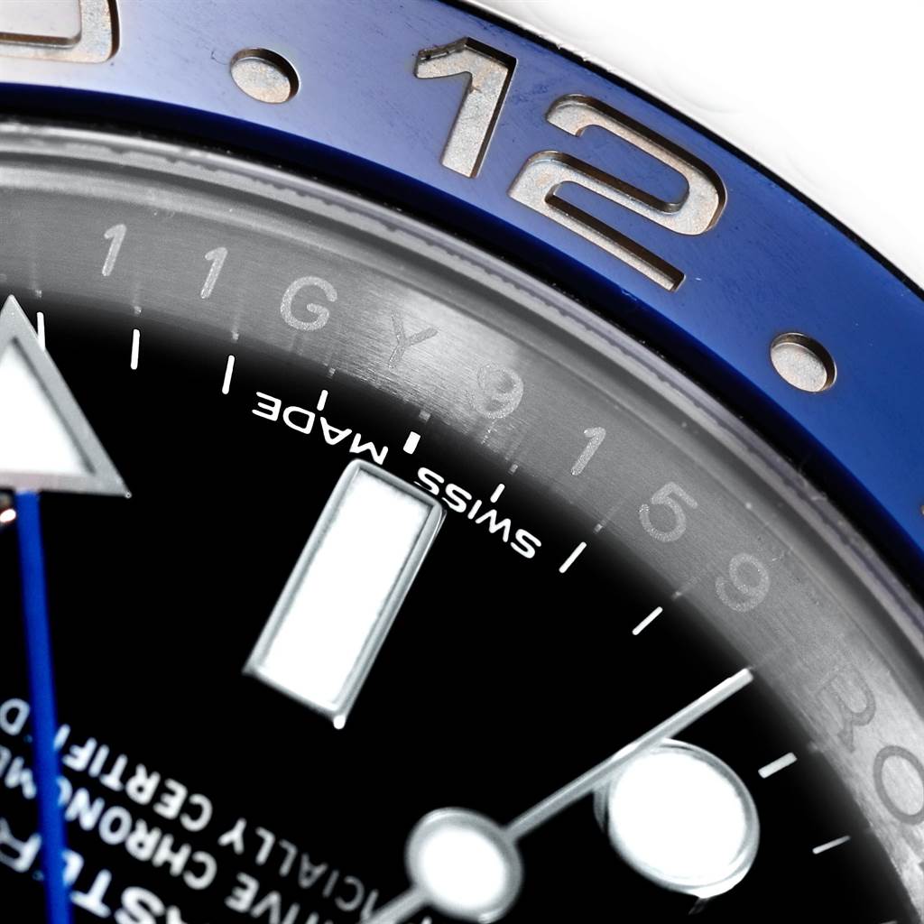 The close-up image highlights the bezel, 12 o'clock marker, and part of the dial of the GMT-Master model by Rolex.