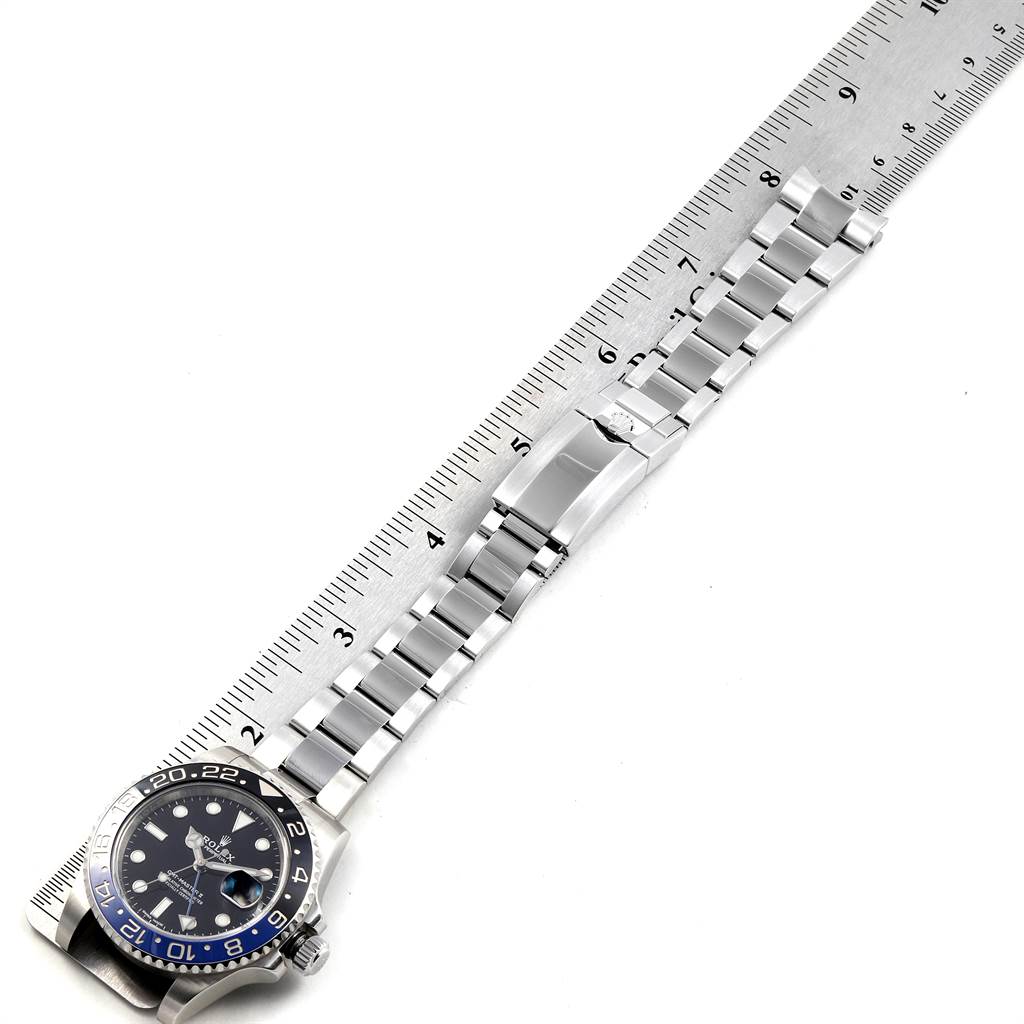 The image shows the Rolex GMT-Master 116710 Men's Stainless Steel Black Dial 116710 Men's Stainless Steel Black Dial watch laid flat with its stainless steel band fully extended next to a ruler.