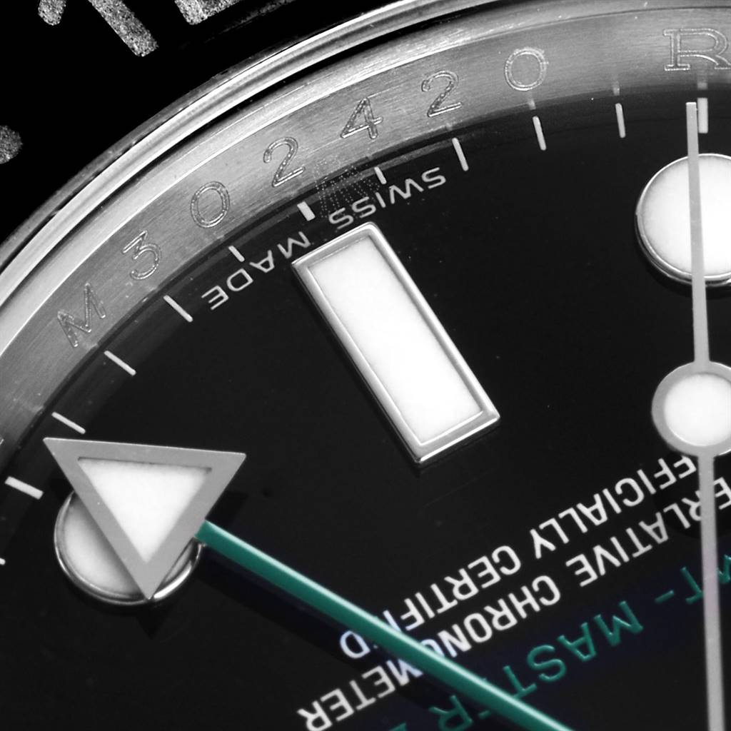 This close-up image of the Rolex GMT-Master 116710 Men's Stainless Steel Black Dial 116710 Men's Stainless Steel Black Dial shows part of the bezel, dial, and the hour and minute hands.