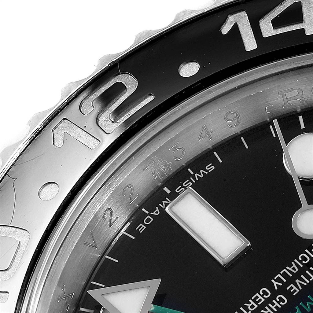 Close-up of the Rolex GMT-Master 116710 Men's Stainless Steel Black Dial 116710 Men's Stainless Steel Black Dial bezel and partially of its dial, showcasing the 12-hour marker in detail.