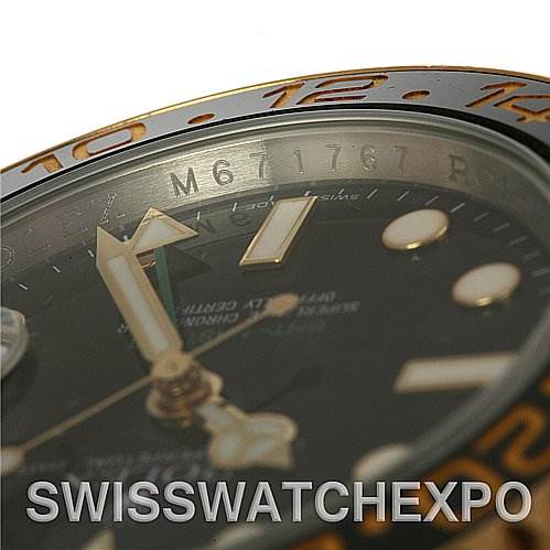 This close-up angle of the Rolex GMT-Master 116713 Men's Stainless Steel Black Dial 116713 Men's Stainless Steel Black Dial watch shows the bezel, a portion of the dial, and part of the serial number.