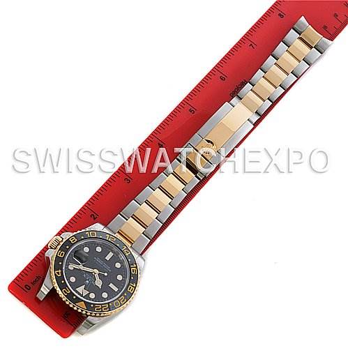 The image shows a Rolex GMT-Master 116713 Men's Stainless Steel Black Dial 116713 Men's Stainless Steel Black Dial watch laid flat on a ruler, highlighting the bracelet and dial from a top-down angle.