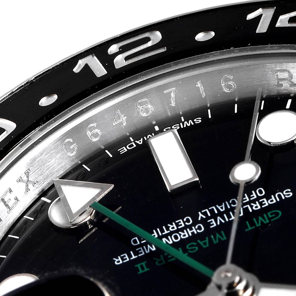 This close-up image shows the bezel, dial, and hands of a Rolex GMT-Master 116710 Men's Stainless Steel Black Dial 116710 Men's Stainless Steel Black Dial model, including part of the 24-hour indicatory.