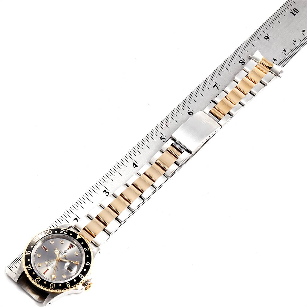 This image shows a Rolex GMT-Master 16713 Men's Stainless Steel Grey Dial 16713 Men's Stainless Steel Grey Dial watch laid flat with a ruler, displaying the entire watch and bracelet.