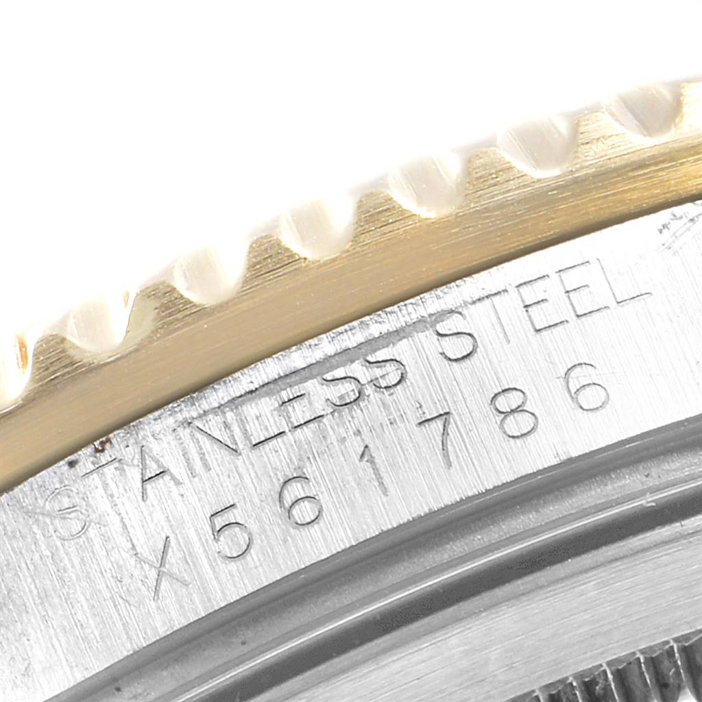 This close-up image shows the edge of the bezel and part of the case back of a Rolex GMT-Master 16713 Men's Stainless Steel Grey Dial 16713 Men's Stainless Steel Grey Dial watch, highlighting the engraved serial number.