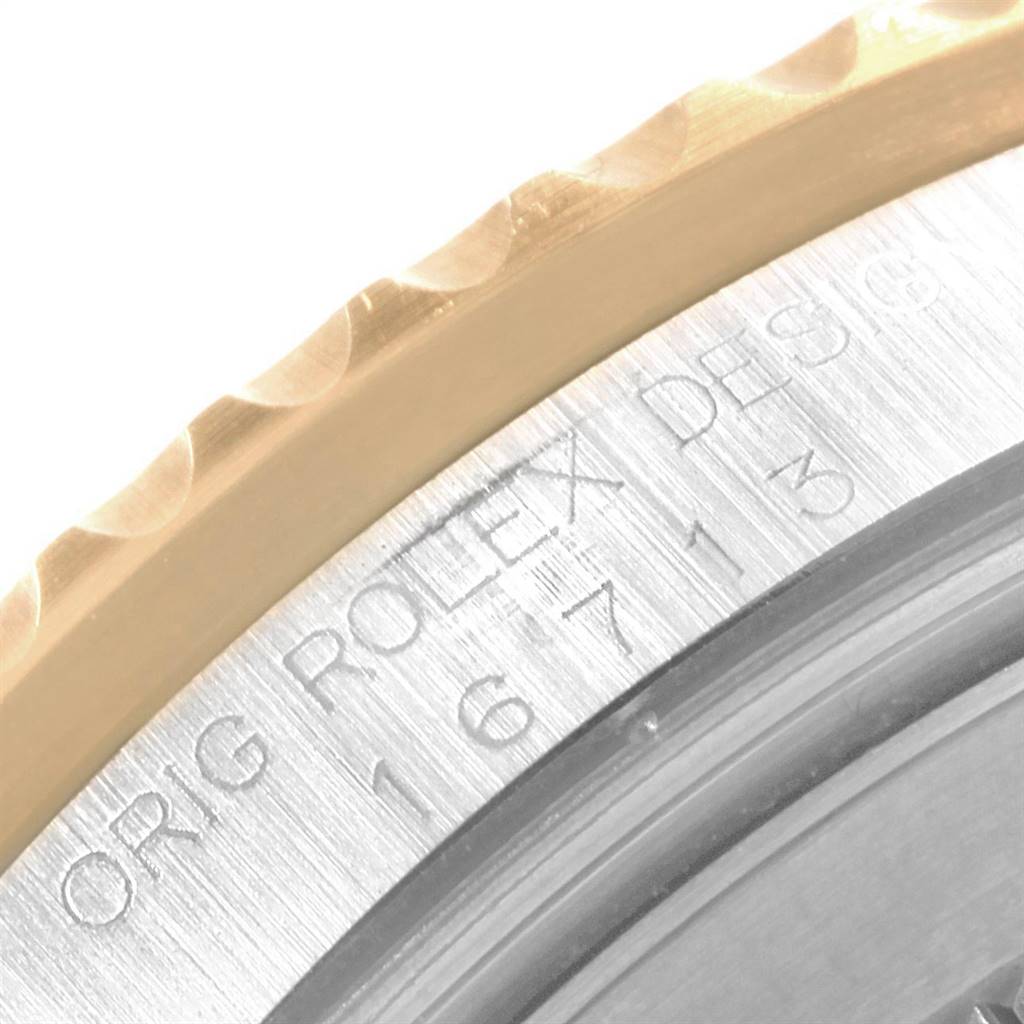 The image shows a close-up of the engraved bezel and case side of the Rolex GMT-Master 16713 Men's Stainless Steel Grey Dial 16713 Men's Stainless Steel Grey Dial watch.