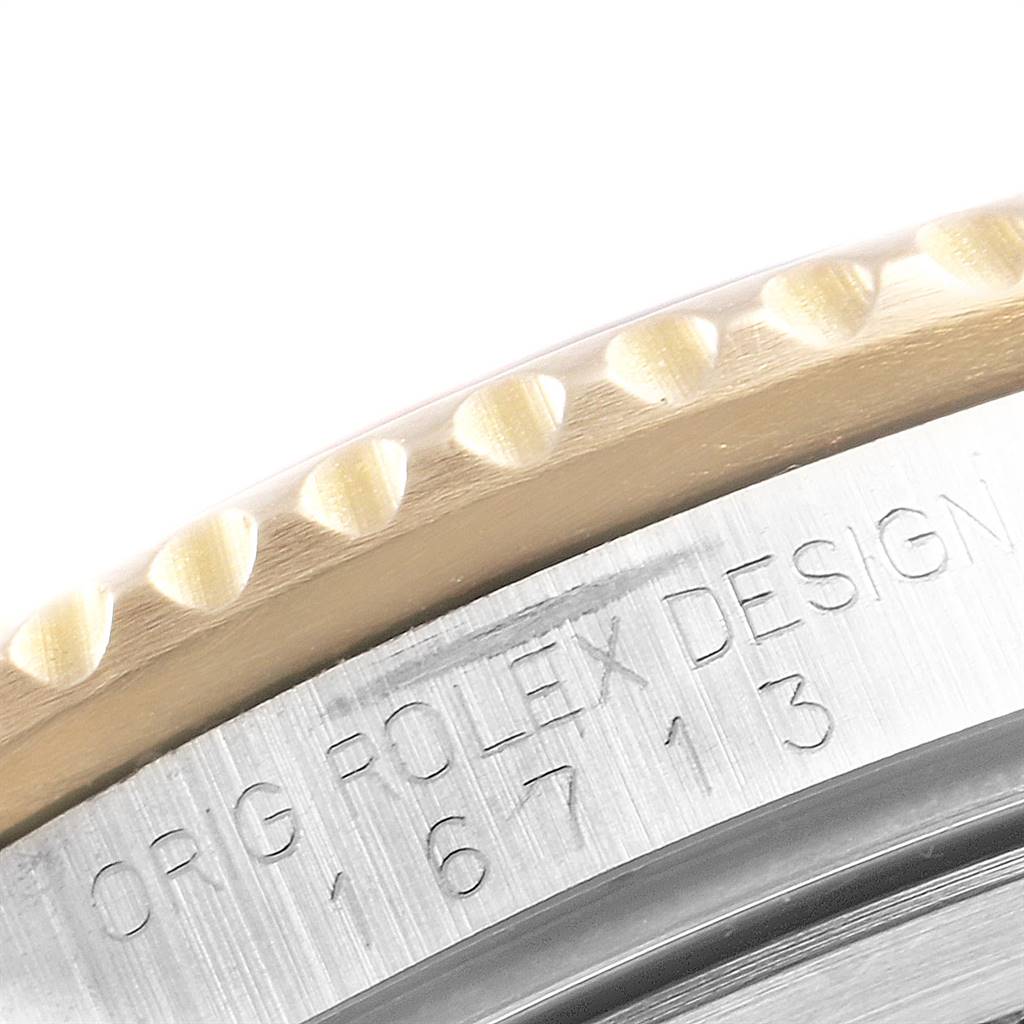 This close-up image shows the edge of the bezel and part of the casing with "Rolex Design" and model number displayed on the Rolex GMT-Master 16713 Men's Stainless Steel Brown Dial 16713 Men's Stainless Steel Brown Dial.