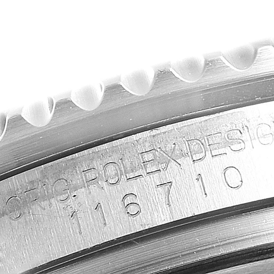 The image shows a close-up angle of the GMT-Master model by Rolex, focusing on the engraved serial and model numbers on the case.