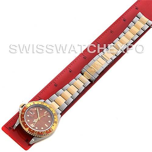 The image shows a Rolex GMT-Master 16713 Men's Stainless Steel Brown Dial 16713 Men's Stainless Steel Brown Dial watch lying flat with a ruler next to its two-tone bracelet and bezel.