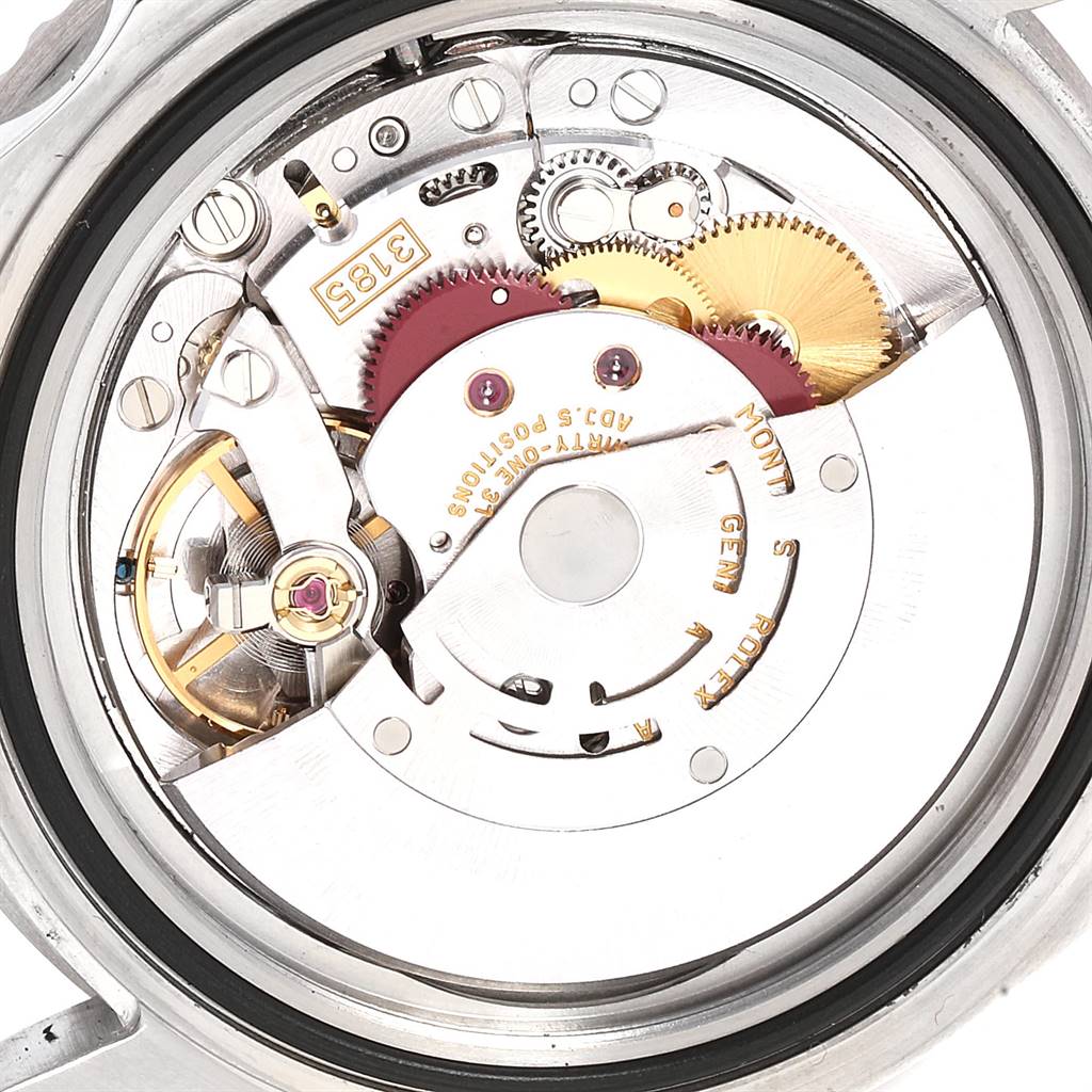 The image shows a close-up of the movement mechanism of a Rolex GMT-Master 16710 Men's Stainless Steel Black Dial 16710 Men's Stainless Steel Black Dial watch, showcasing gears and components.