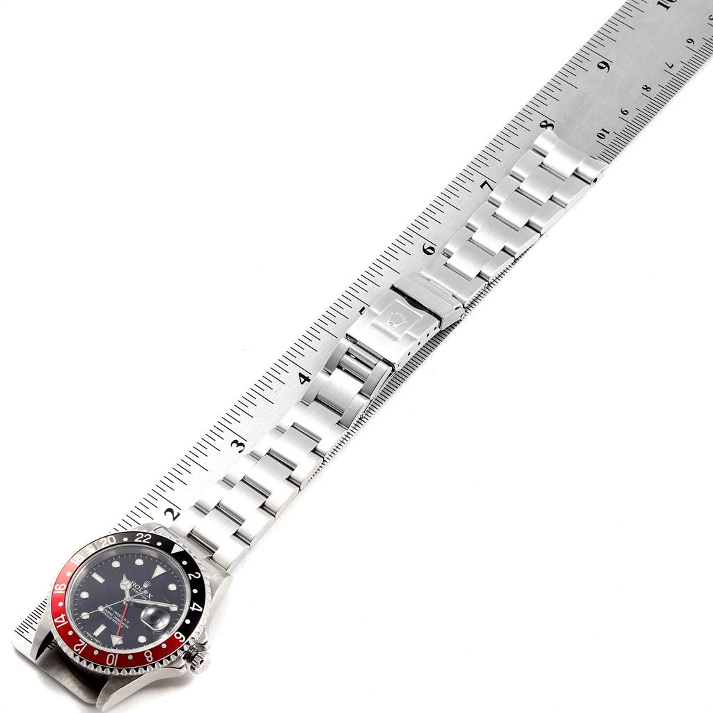 The image shows a top-down view of a Rolex GMT-Master 16710 Men's Stainless Steel Black Dial 16710 Men's Stainless Steel Black Dial watch, focusing on the face, bezel, and full stainless steel bracelet measured against a ruler.