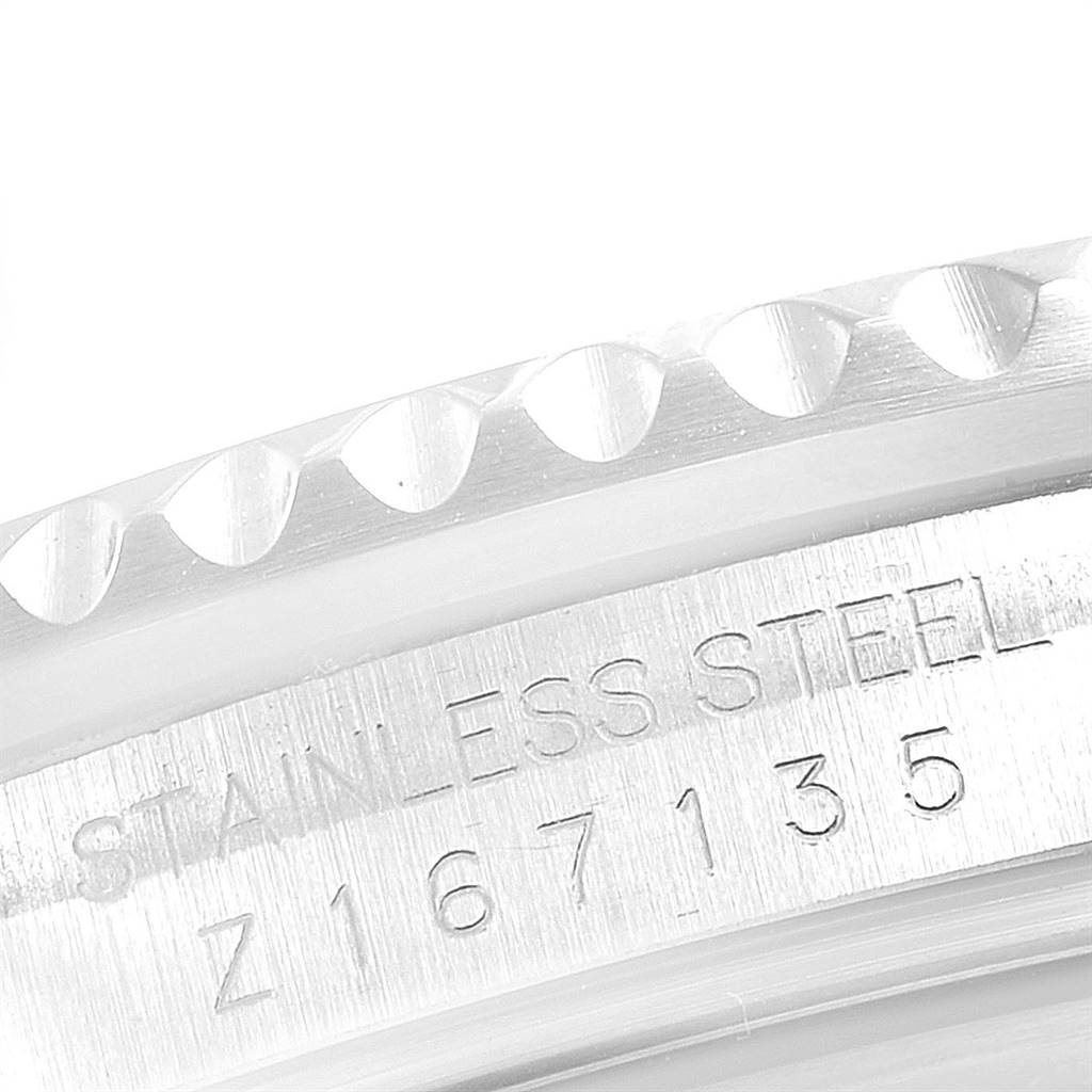 This close-up image shows the engraved side of the stainless steel case of a Rolex GMT-Master 16710 Men's Stainless Steel Black Dial 16710 Men's Stainless Steel Black Dial watch.