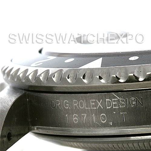 This image shows a close-up side view of the bezel and case of a Rolex GMT-Master 16710 Men's Stainless Steel Black Dial 16710 Men's Stainless Steel Black Dial model, specifically focusing on the engraving.