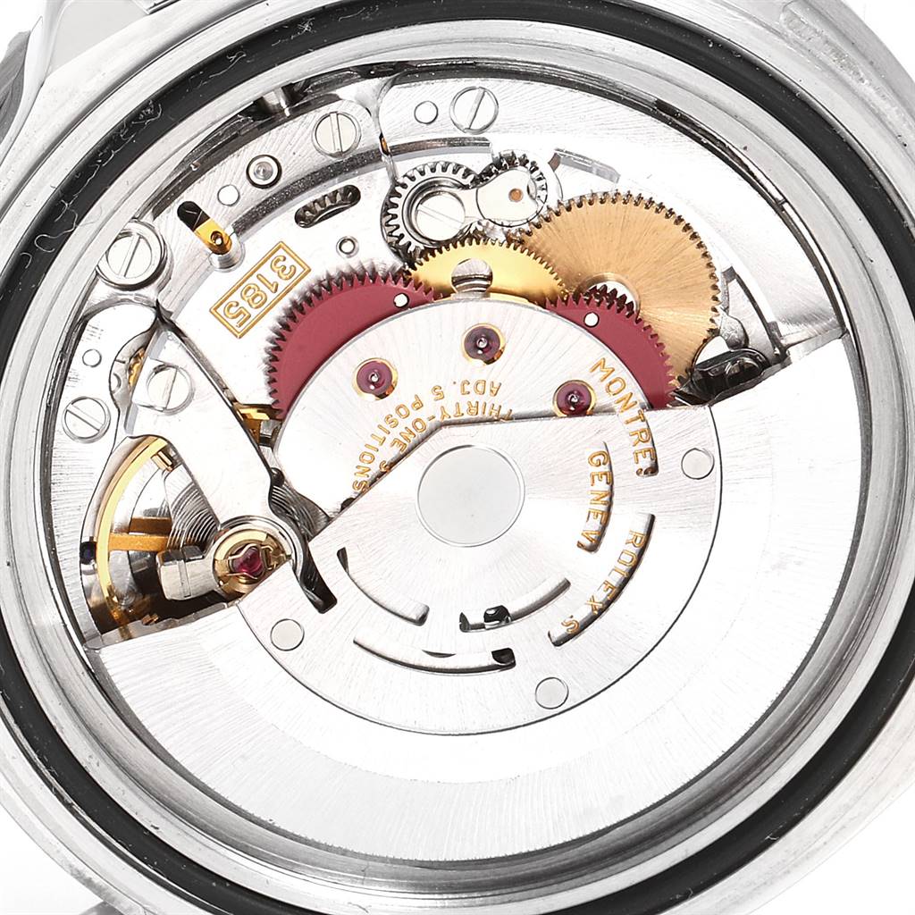 The image shows a close-up view of the movement mechanism of the Rolex GMT-Master 16710 Men
s Stainless Steel Black Dial 16710 Men
s Stainless Steel Black Dial watch, focusing on its internal gears and components.