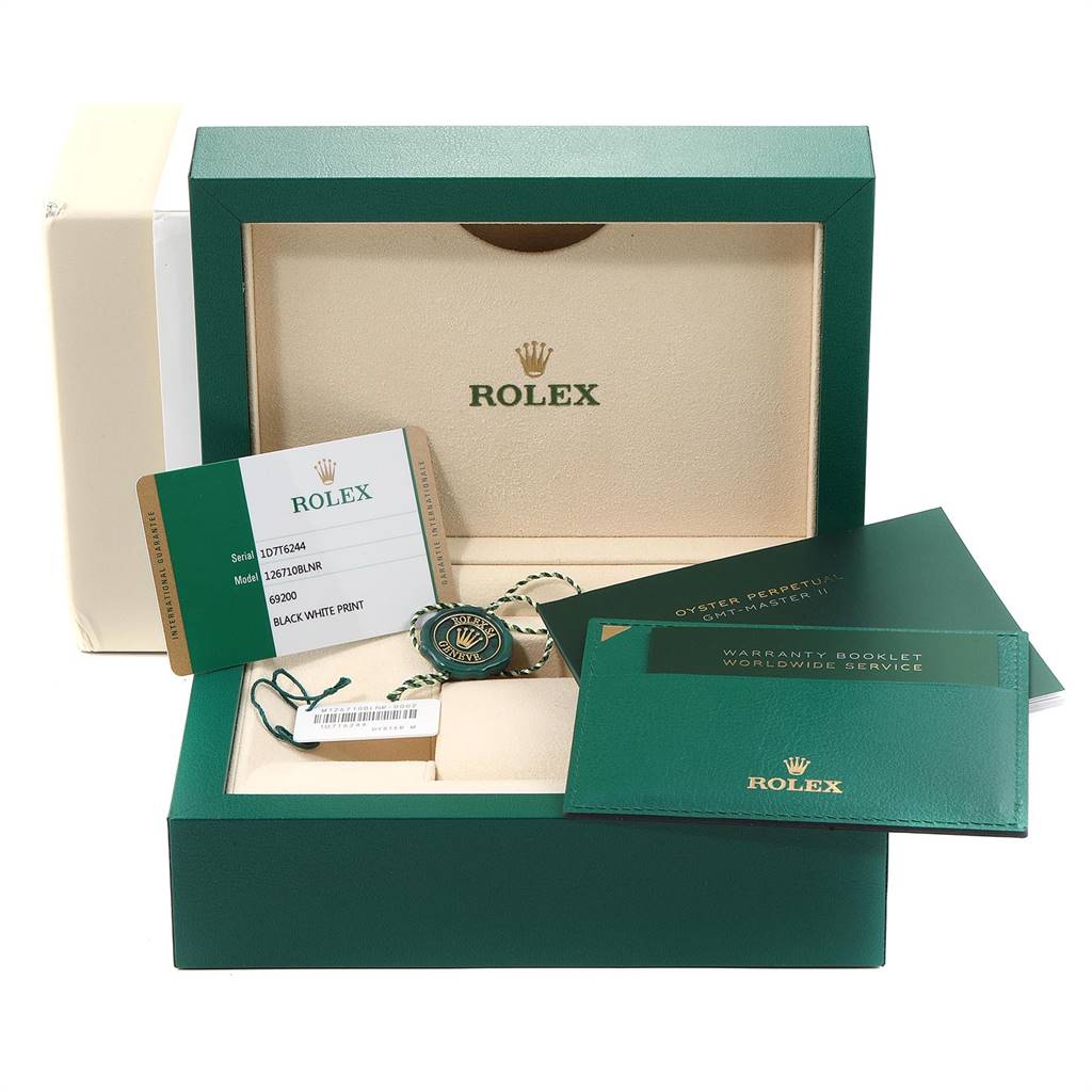The image shows a Rolex GMT-Master 126710 Men's Stainless Steel Black Dial 126710 Men's Stainless Steel Black Dial watch box with warranty booklets, a serial number card, and a hang tag.