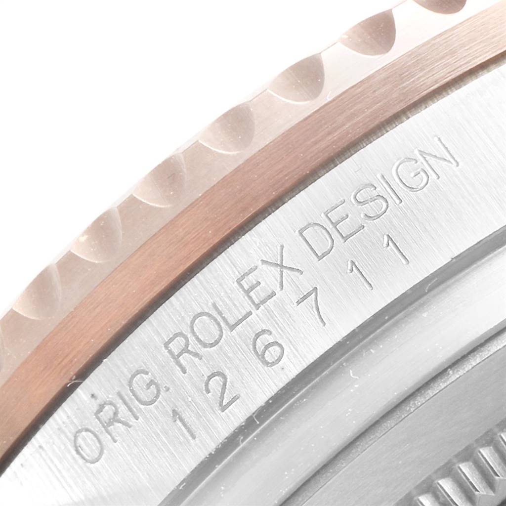 The image shows a close-up angle of the side of the Rolex GMT-Master 126711 Men's Steel and Gold (two tone) Black Dial 126711 Men's Steel and Gold (two tone) Black Dial watch, focusing on the engraved original design number.