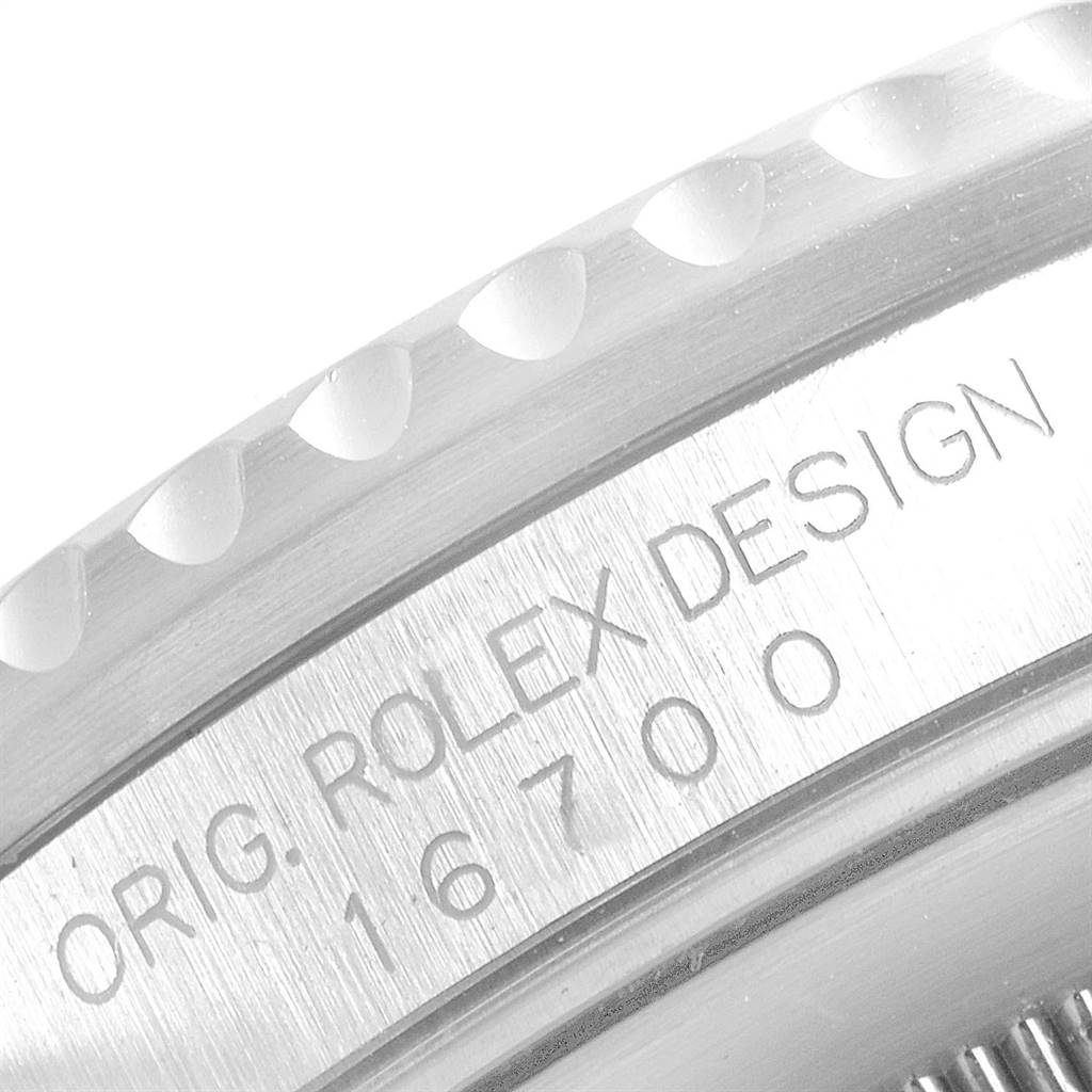 This image shows a close-up of the bezel and engraved side of a Rolex GMT-Master 16700 Men's Stainless Steel Black Dial 16700 Men's Stainless Steel Black Dial, model number 16700.