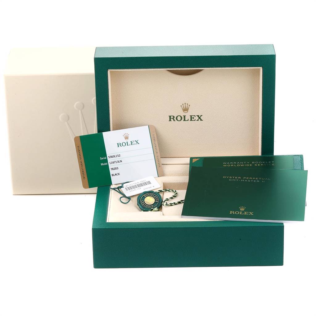 This image shows a Rolex GMT-Master 116713 Men's Stainless Steel Black Dial 116713 Men's Stainless Steel Black Dial packaging with a warranty card, booklet, and accessories in an angled open view.