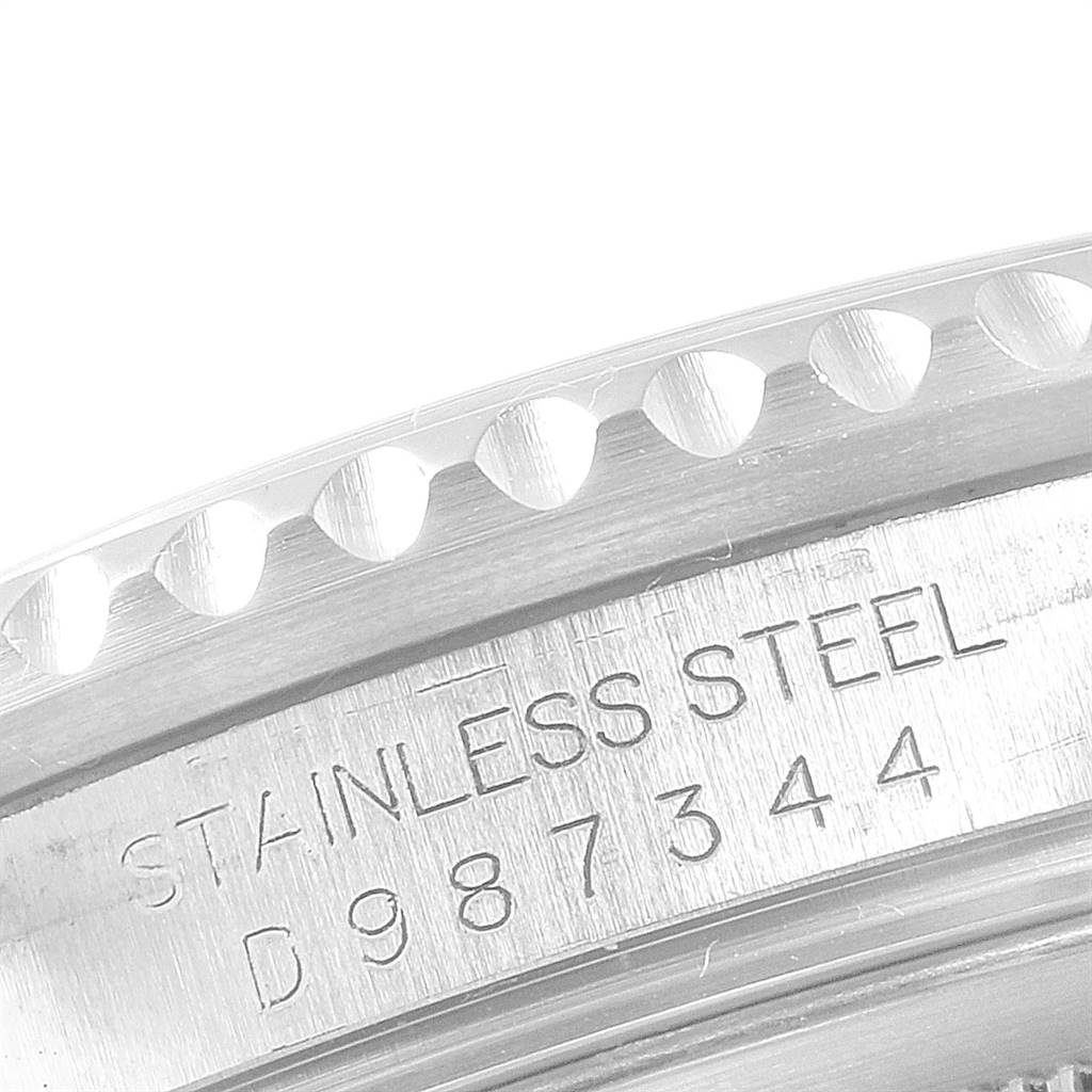 This close-up image shows the edge of the bezel and serial number engraving on the case of a Rolex GMT-Master 16710 Men's Stainless Steel Black Dial 16710 Men's Stainless Steel Black Dial watch.