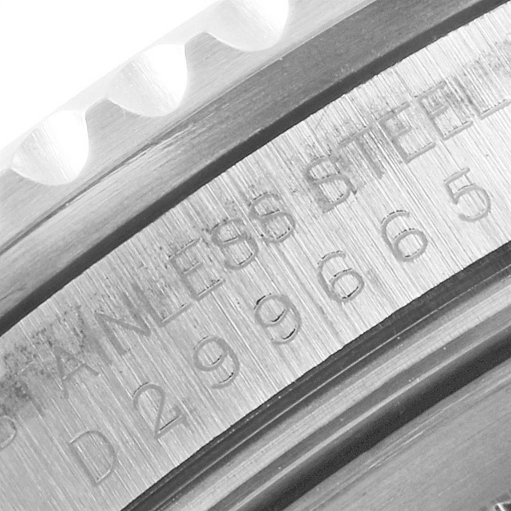 This close-up image shows the engraved bezel and part of the case of a Rolex GMT-Master 16710 Men's Stainless Steel Black Dial 16710 Men's Stainless Steel Black Dial watch.