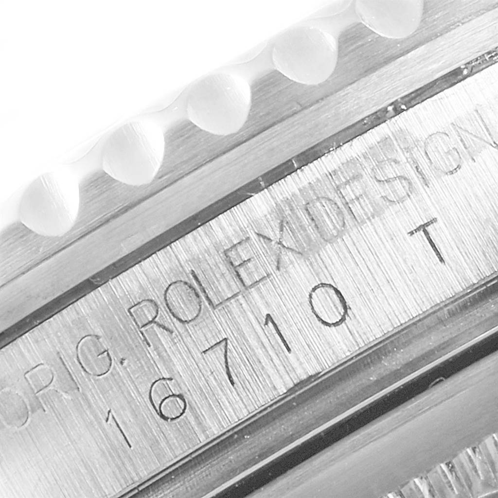 This close-up image shows the side engraving on the bezel and the case of a Rolex GMT-Master 16710 Men's Stainless Steel Black Dial 16710 Men's Stainless Steel Black Dial model, displaying the serial and model number details.