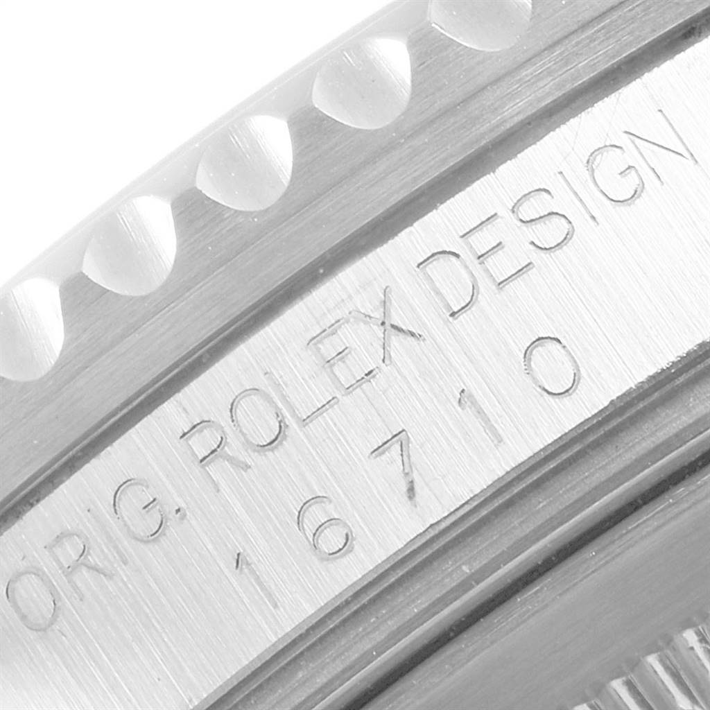 The image shows a close-up of the engraved case side and bezel of the Rolex GMT-Master 16710 Men
s Stainless Steel Black Dial 16710 Men
s Stainless Steel Black Dial model 16710.