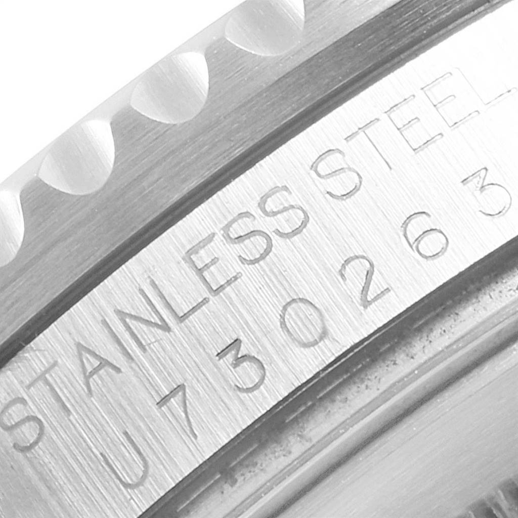 This image shows the engraved serial number and part of the stainless steel bezel of a Rolex GMT-Master 16710 Men
s Stainless Steel Black Dial 16710 Men
s Stainless Steel Black Dial watch at a close-up angle.