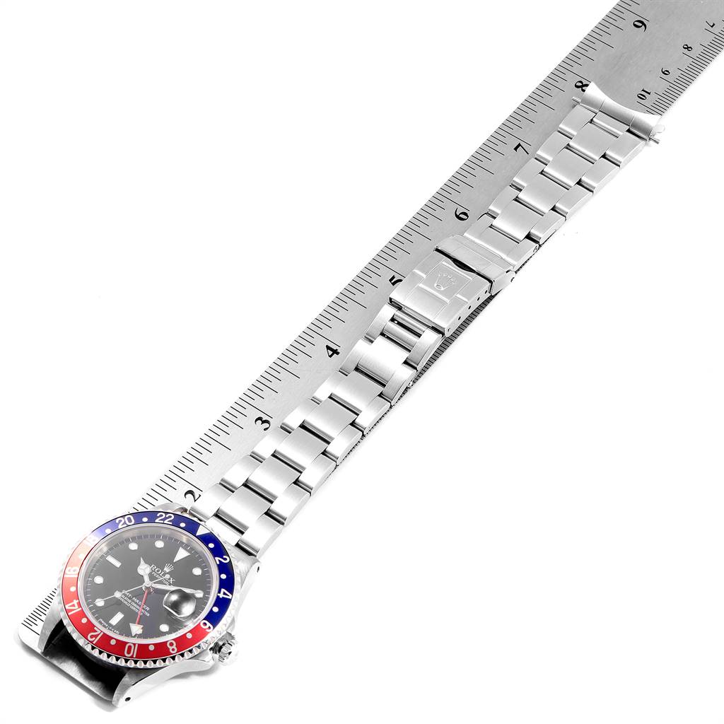 The image shows a Rolex GMT-Master 16700 Men's Stainless Steel Black Dial 16700 Men's Stainless Steel Black Dial watch laid flat and measured against a ruler, displaying the bezel and bracelet from an overhead angle.