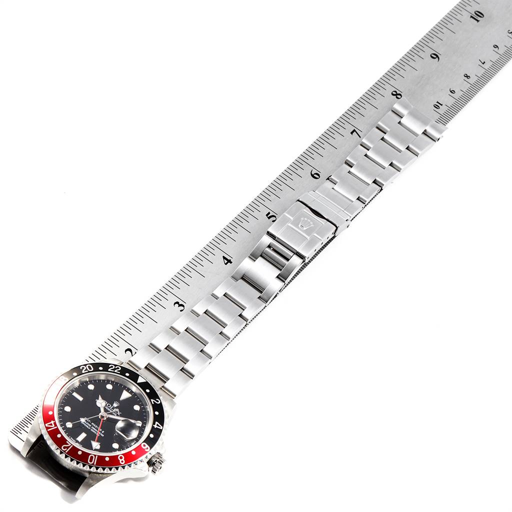 This image shows a Rolex GMT-Master 16710 Men's Stainless Steel Black Dial 16710 Men's Stainless Steel Black Dial watch laid flat with its face and bracelet measured against a ruler.
