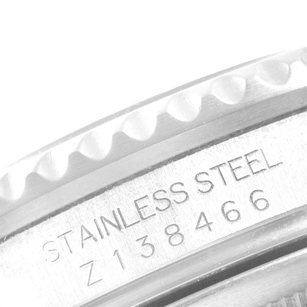 The image shows a close-up of the side of a Rolex GMT-Master 16710 Men's Stainless Steel Black Dial 16710 Men's Stainless Steel Black Dial, highlighting the stainless steel and serial number.