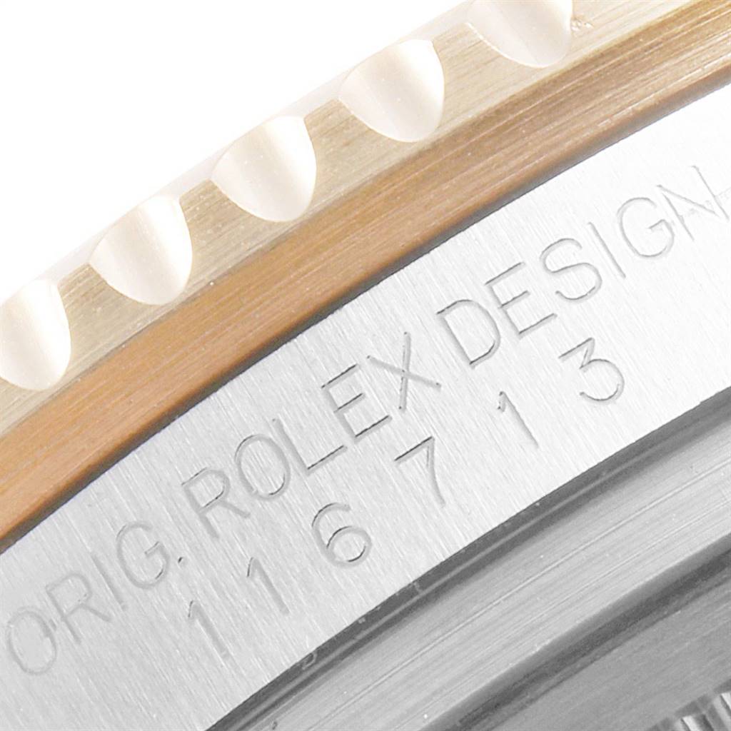 This close-up image focuses on the engraved bezel edge of a Rolex GMT-Master 116713 Men's Stainless Steel Black Dial 116713 Men's Stainless Steel Black Dial.