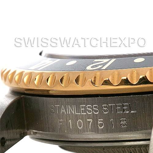 This image shows a close-up of the bezel and part of the case side of a Rolex GMT-Master 16713 Men's Stainless Steel Black Dial 16713 Men's Stainless Steel Black Dial watch.