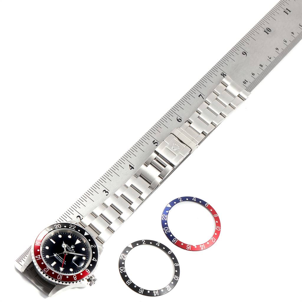 This image shows a Rolex GMT-Master 16710 Men's Stainless Steel Black Dial 16710 Men's Stainless Steel Black Dial watch with its bracelet laid flat and two separate bezel inserts.