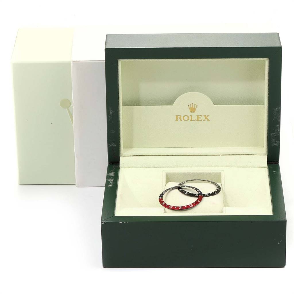 The image shows a Rolex GMT-Master 16710 Men's Stainless Steel Black Dial 16710 Men's Stainless Steel Black Dial watch box containing two bezel inserts, one black and one in red and black.