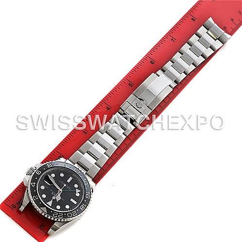 This image shows a Rolex GMT-Master 116710 Men's Stainless Steel Black Dial 116710 Men's Stainless Steel Black Dial watch laid flat with a red ruler indicating its length.