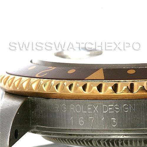 The image shows a side angle of the Rolex GMT-Master 16713 Men's Stainless Steel Brown Dial 16713 Men's Stainless Steel Brown Dial's bezel, crown guard, and part of the case with the model number 16713 engraved.