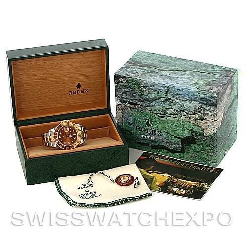 This image shows a Rolex GMT-Master 16713 Men's Stainless Steel Brown Dial 16713 Men's Stainless Steel Brown Dial watch with its wooden box, outer box, warranty card, booklet, and protective cloth.