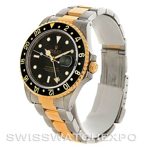 This image shows a Rolex GMT-Master 16713 Men's Stainless Steel Black Dial 16713 Men's Stainless Steel Black Dial watch at a three-quarter angle, highlighting its dial, bezel, and two-tone bracelet.