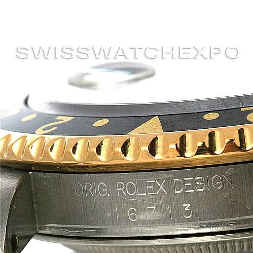 The image shows a close-up of the side of the Rolex GMT-Master 16713 Men's Stainless Steel Black Dial 16713 Men's Stainless Steel Black Dial's bezel and case, highlighting its design and model number 16713.