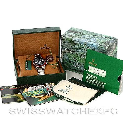 The image shows a Rolex GMT-Master 16710 Men's Stainless Steel Black Dial 16710 Men's Stainless Steel Black Dial watch at an oblique angle, along with its box, manuals, tags, and authenticity card.