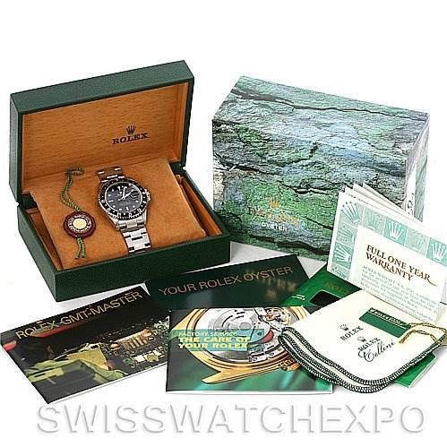 The image shows a Rolex GMT-Master 16710 Men's Stainless Steel Black Dial 16710 Men's Stainless Steel Black Dial watch at a three-quarters angle, with its box, warranty card, manuals, and other accessories.