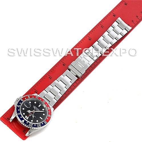 The image shows a top-down view of a Rolex GMT-Master 16710 Men's Stainless Steel Black Dial 16710 Men's Stainless Steel Black Dial watch laid flat against a ruler, displaying its face and full bracelet.