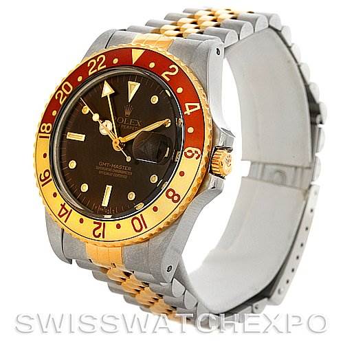 The image shows a Rolex GMT-Master 16753 Men
s Stainless Steel Brown Dial 16753 Men
s Stainless Steel Brown Dial watch at a 3/4 angle, highlighting its two-tone bracelet, black dial, and red and gold bezel.